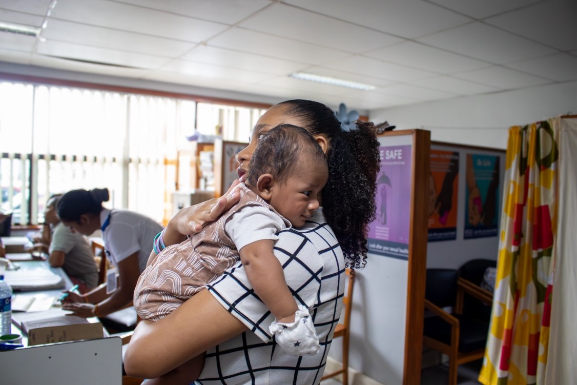 Mother soothes baby after vaccination